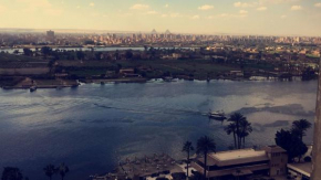 Гостиница Breathtaking Nile View with Pyramids in back drop  Каир